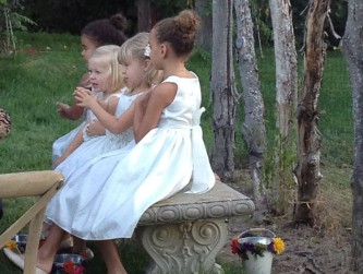 Three flower girls on our stone bench